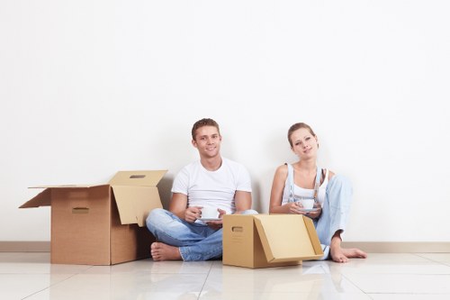 Professional movers handling furniture in a Colindale flat move