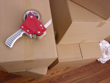 Packed boxes and furniture ready for transport in a Colindale property
